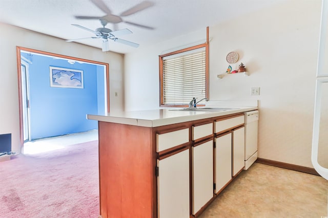 kitchen with ceiling fan, white cabinets, sink, dishwasher, and light carpet