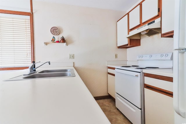 kitchen with white appliances, sink, and white cabinets