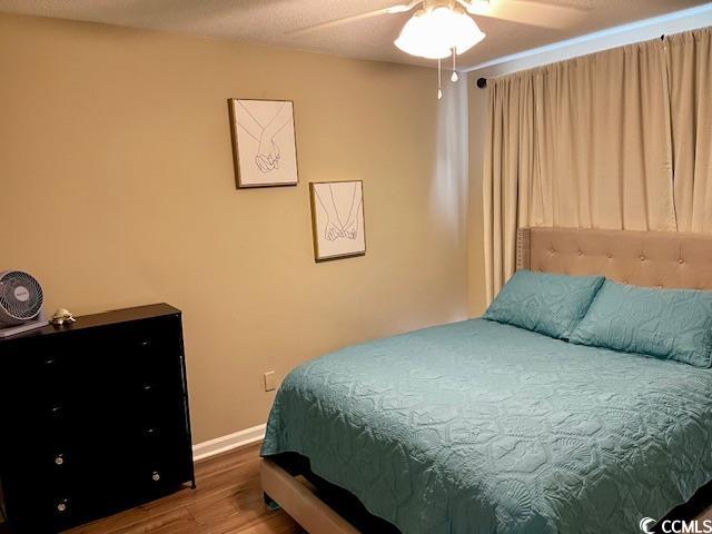 bedroom with wood-type flooring and ceiling fan