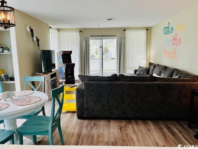 living room featuring an inviting chandelier and hardwood / wood-style flooring