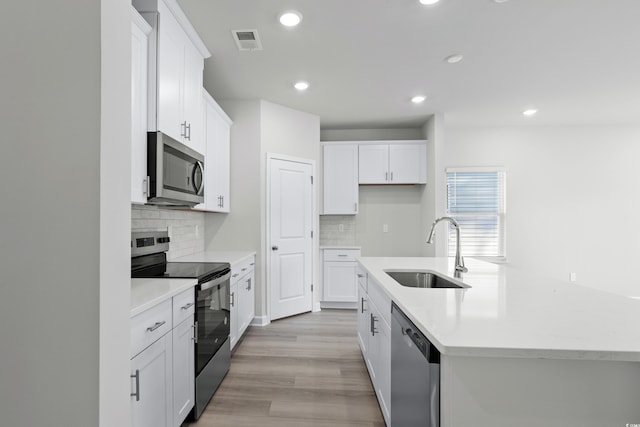 623 Blackthorne Cir NW, Calabash, NC 28467 - kitchen with appliances with stainless steel finishes, tasteful backsplash, light countertops, and recessed lighting