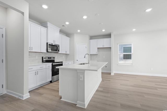 623 Blackthorne Cir NW, Calabash, NC 28467 - kitchen featuring stainless steel appliances, light wood-style flooring, tasteful backsplash, white cabinetry, and recessed lighting