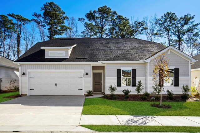623 Blackthorne Cir NW, Calabash, NC 28467 - view of front of house with an attached garage, concrete driveway, a front yard, and a shingled roof