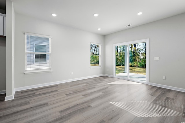 623 Blackthorne Cir NW, Calabash, NC 28467 - empty room featuring plenty of natural light, wood finished floors, and recessed lighting