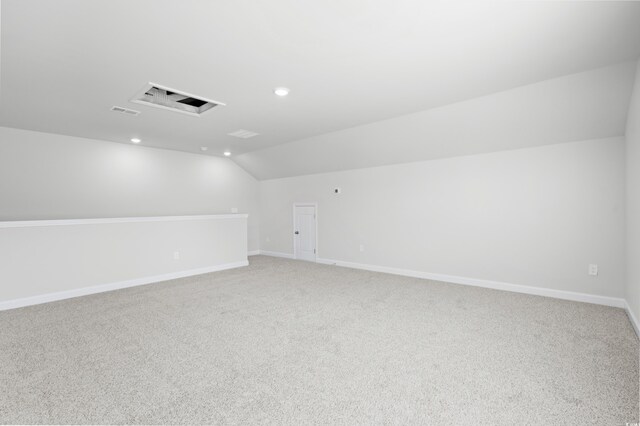 additional living space with carpet flooring and lofted ceiling