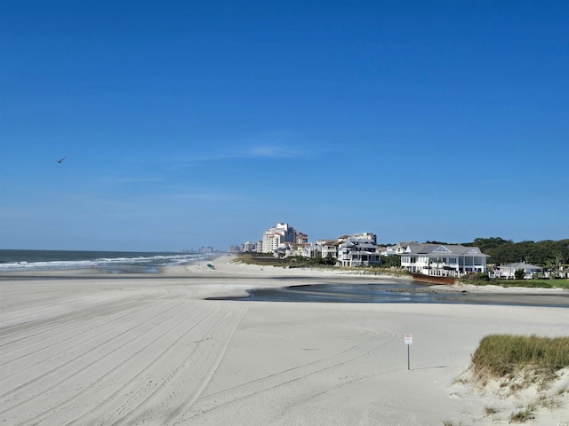 view of street with a beach view and a water view