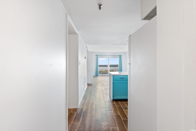 hallway with dark hardwood / wood-style flooring