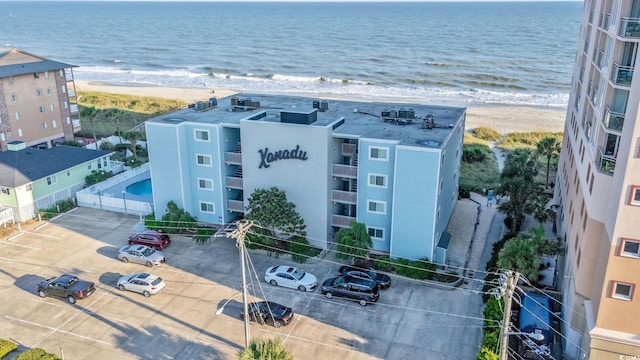 bird's eye view featuring a water view and a beach view