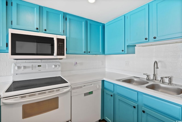 kitchen featuring blue cabinetry, sink, white appliances, and decorative backsplash