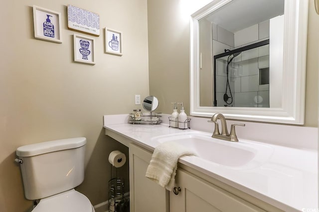 bathroom with walk in shower, vanity, and toilet