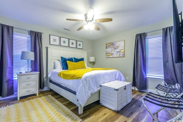 bedroom with ceiling fan and dark hardwood / wood-style floors