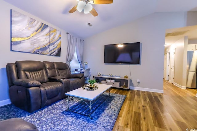 living room with vaulted ceiling, ceiling fan, and hardwood / wood-style flooring