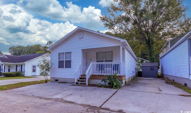 bungalow-style house with a shed and a porch