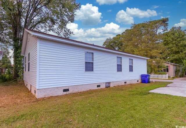 view of property exterior featuring a patio and a yard