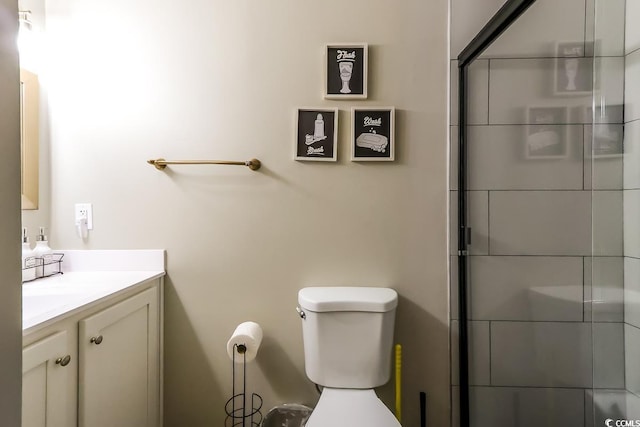 bathroom with walk in shower, vanity, and toilet