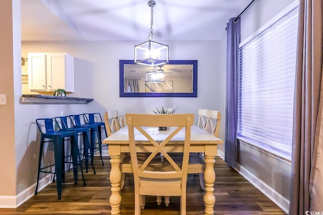 dining space featuring a notable chandelier and dark hardwood / wood-style flooring