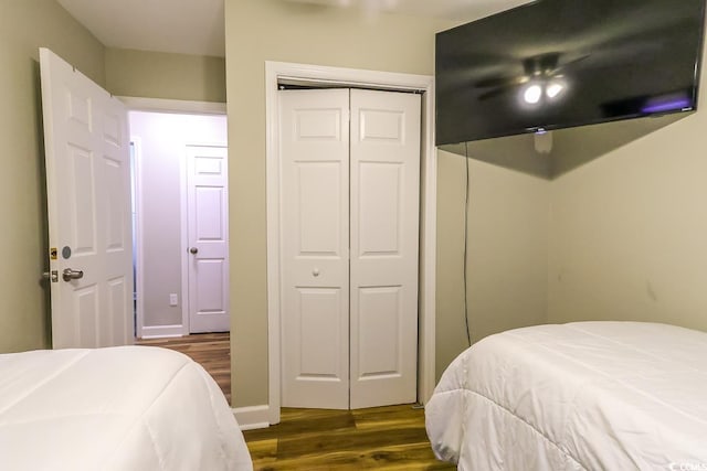 bedroom with ceiling fan and dark wood-type flooring