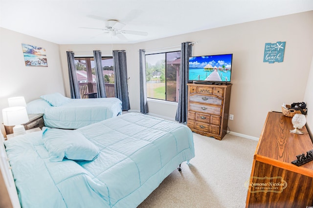 carpeted bedroom featuring ceiling fan and access to outside