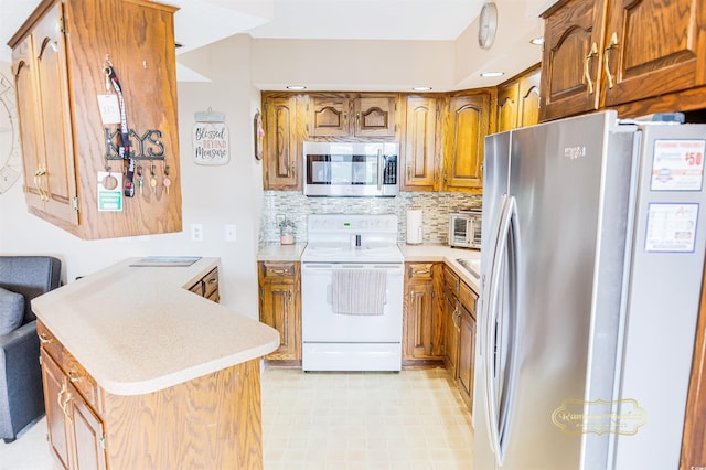 kitchen with stainless steel appliances and tasteful backsplash