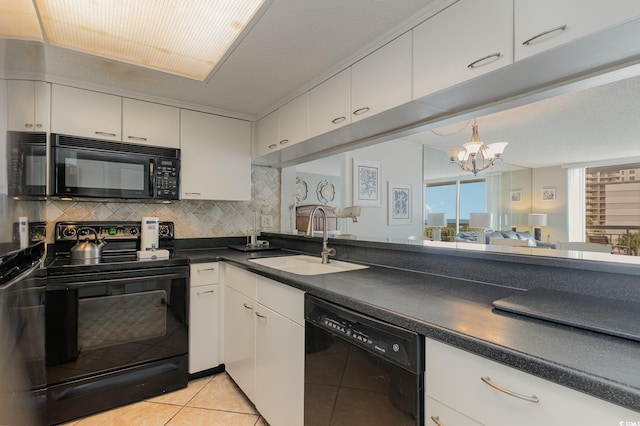 kitchen with light tile patterned flooring, white cabinets, black appliances, sink, and a chandelier