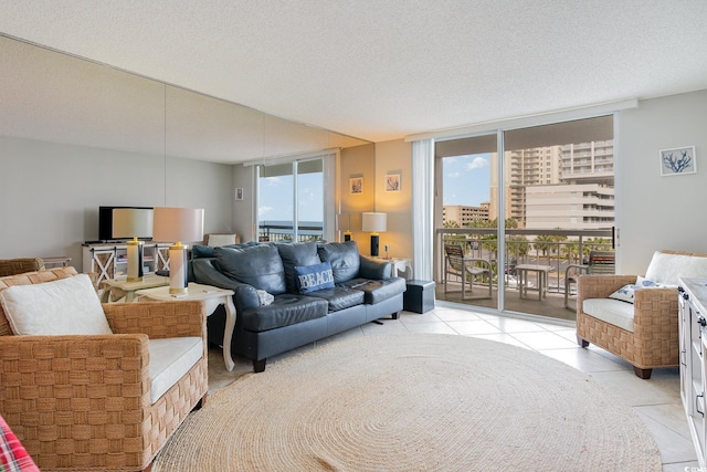 living room featuring expansive windows, a textured ceiling, and a wealth of natural light