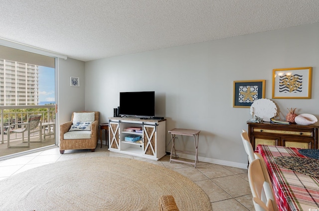 living room featuring a textured ceiling and light tile patterned floors