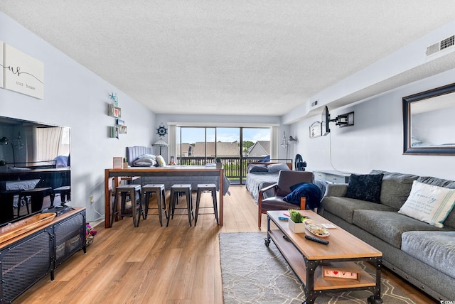 living room featuring a textured ceiling and hardwood / wood-style flooring