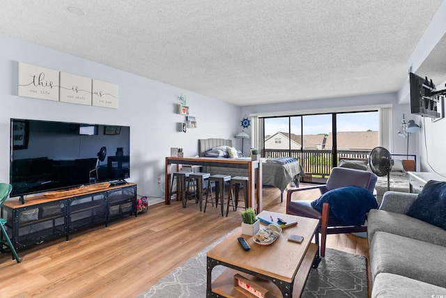 living room with wood-type flooring and a textured ceiling