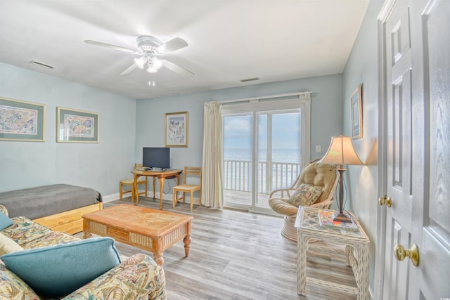 living room with light wood-type flooring and ceiling fan