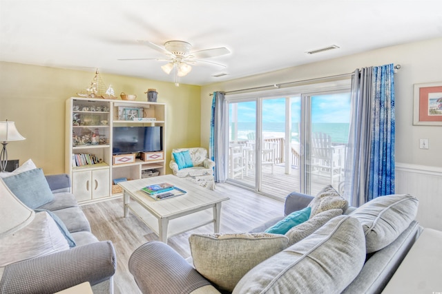 living room with light wood-type flooring and ceiling fan