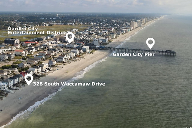 birds eye view of property with a water view and a view of the beach