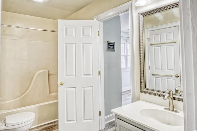 full bathroom featuring tub / shower combination, hardwood / wood-style floors, vanity, and toilet