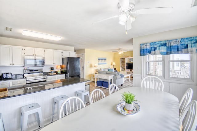 dining space featuring ceiling fan and light hardwood / wood-style flooring