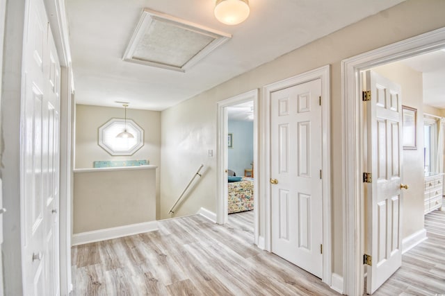 hallway with light hardwood / wood-style flooring