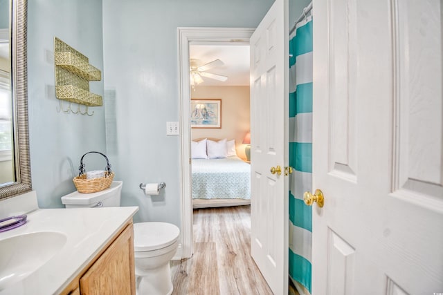 bathroom featuring ceiling fan, vanity, toilet, and hardwood / wood-style flooring