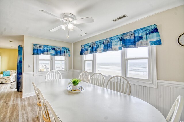 dining area with ceiling fan and light wood-type flooring