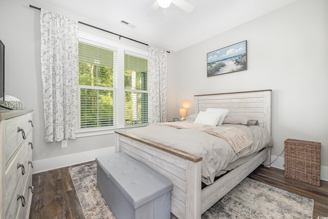 bedroom with ceiling fan and dark hardwood / wood-style floors