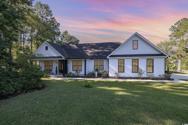 modern farmhouse with a lawn