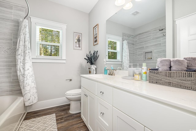 full bathroom featuring shower / bath combo, hardwood / wood-style flooring, vanity, and toilet