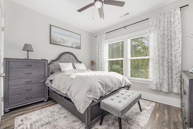 bedroom with ceiling fan and dark wood-type flooring