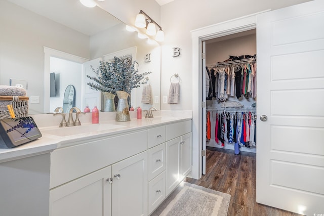 1886 Southwood Dr, Myrtle Beach, SC 29575 - bathroom with wood finished floors, double vanity, a sink, and a walk in closet