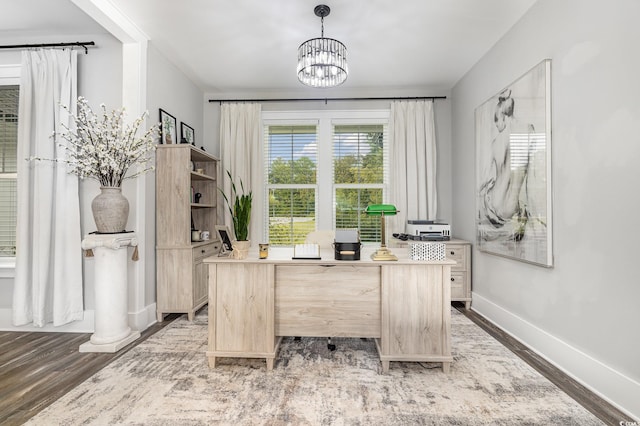 office space featuring an inviting chandelier and wood-type flooring