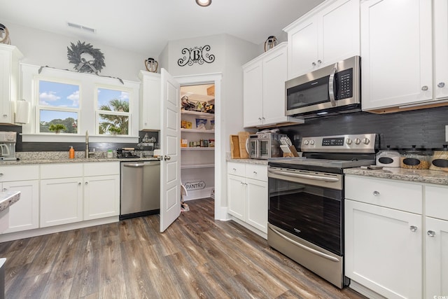 1886 Southwood Dr, Myrtle Beach, SC 29575 - kitchen featuring visible vents, white cabinetry, a sink, and appliances with stainless steel finishes
