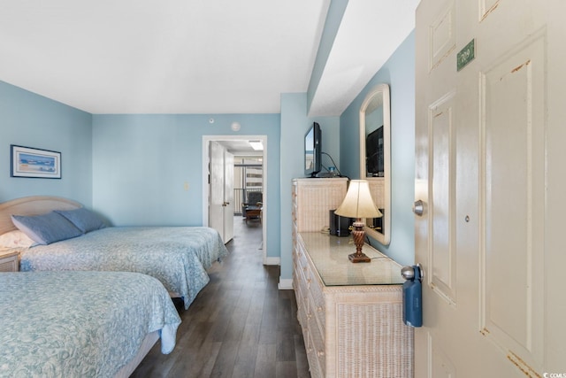 bedroom with a closet and dark hardwood / wood-style floors