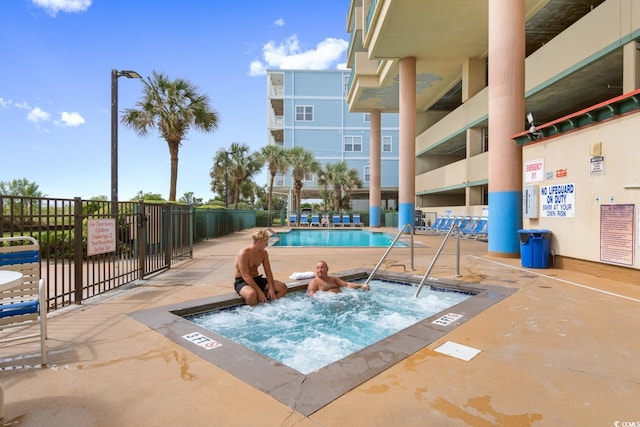 view of pool with a community hot tub