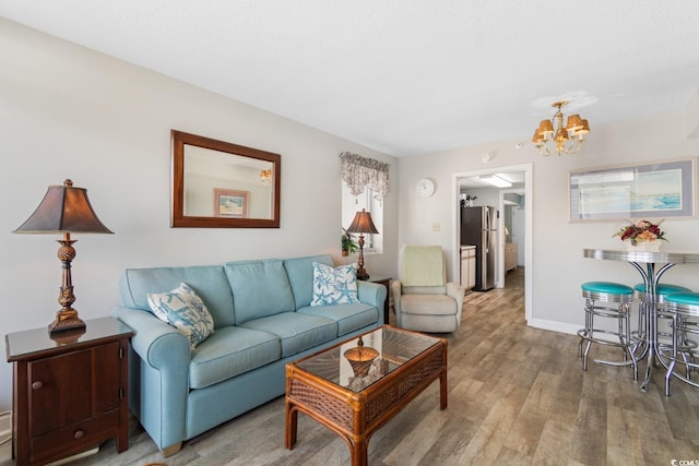 living room with an inviting chandelier and hardwood / wood-style flooring