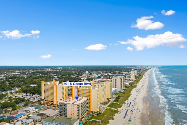 birds eye view of property with a water view and a beach view