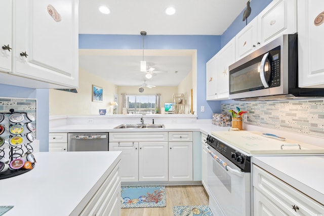 kitchen with ceiling fan, white cabinets, sink, stainless steel appliances, and light wood-type flooring