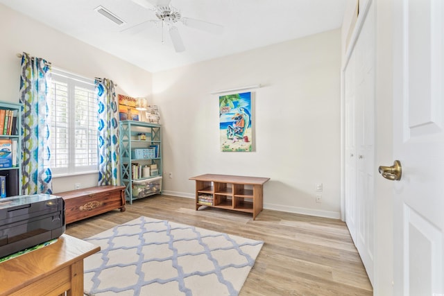 living area with ceiling fan and light wood-type flooring