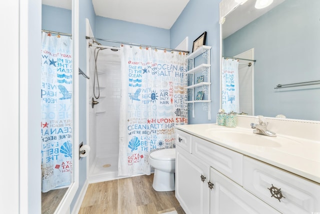 bathroom featuring a shower with curtain, hardwood / wood-style floors, vanity, and toilet